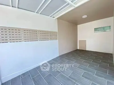 Spacious modern storage room with tiled flooring and sleek design.