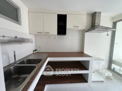 Modern kitchen with sleek countertops and stainless steel sink