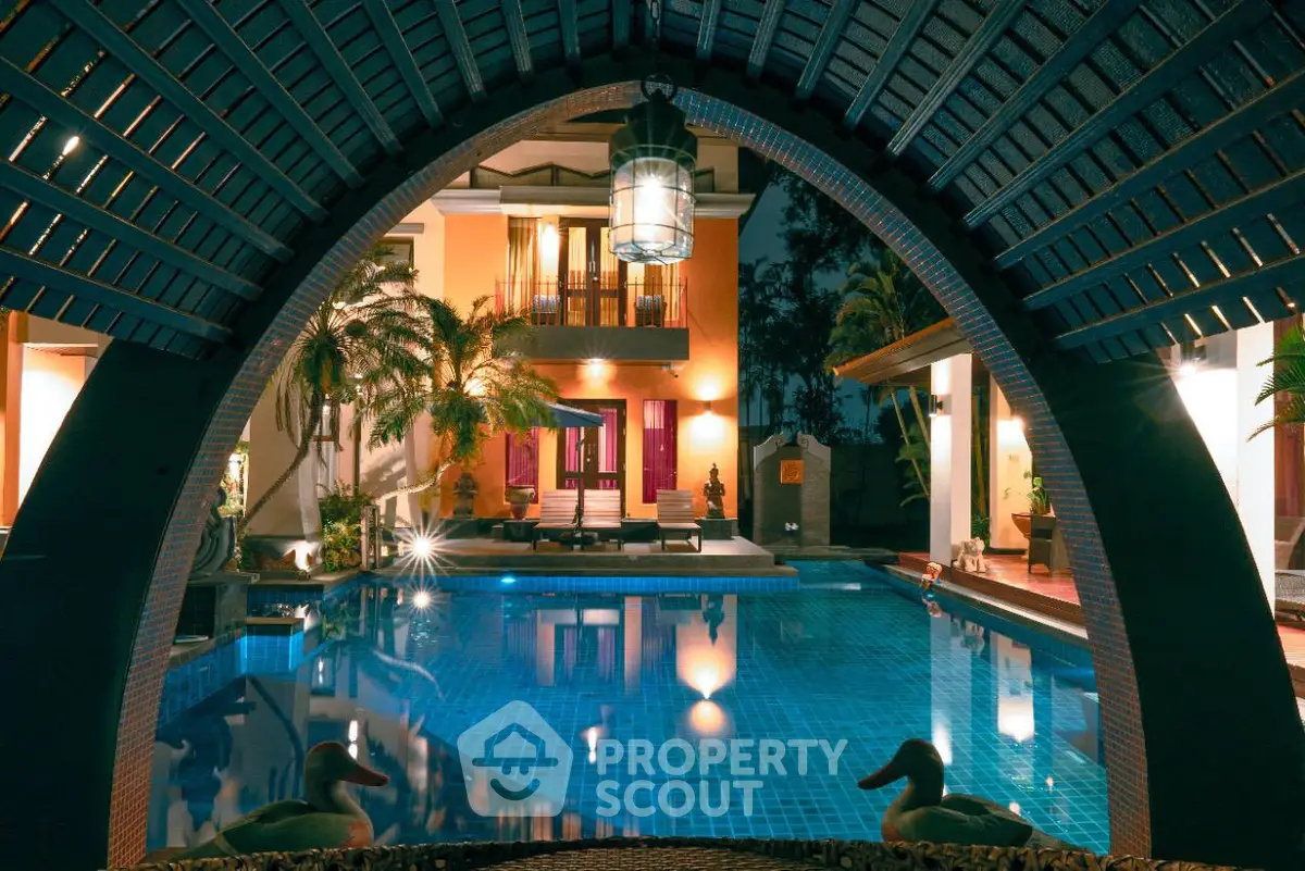 Luxurious villa with stunning pool and elegant night lighting, perfect for serene living.