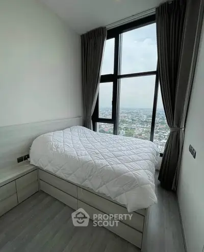 Modern bedroom with large window offering stunning city view, featuring sleek design and cozy ambiance.