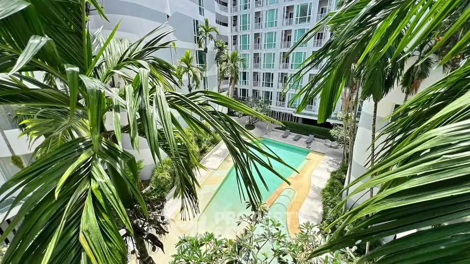 Luxurious condominium with tropical pool view surrounded by lush greenery and modern architecture.