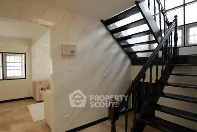 Stylish interior with elegant staircase and cozy living area, perfect for modern living.