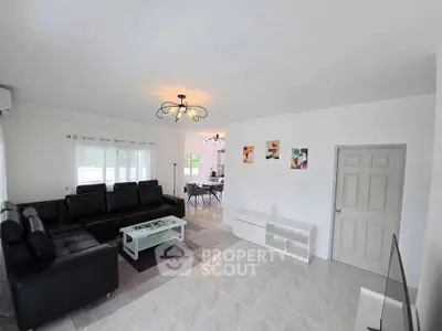 Spacious modern living room with elegant black leather sofa and stylish lighting