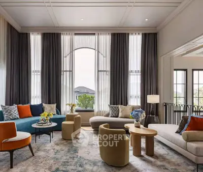 Luxurious living room with elegant furniture and large windows offering natural light.
