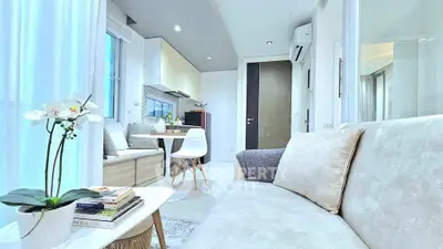 Modern living room with elegant decor and open kitchen layout