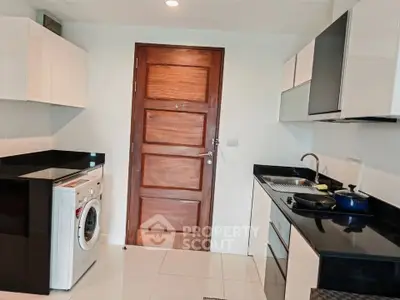 Modern kitchen with sleek cabinets and washing machine