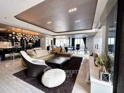 Luxurious open-plan living room with modern decor and elegant lighting