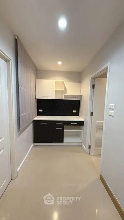 Modern minimalist kitchen with sleek black and white cabinetry