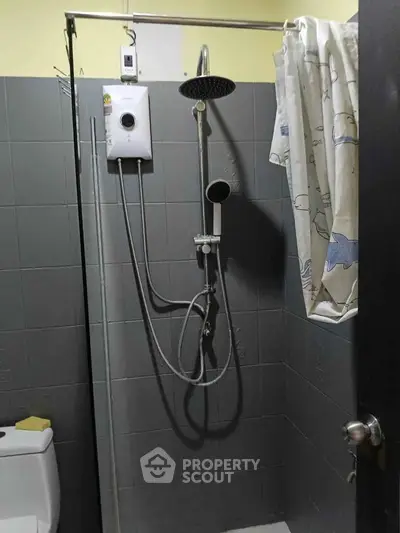 Compact bathroom with modern shower and water heater