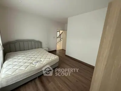 Spacious bedroom with modern design and wooden flooring
