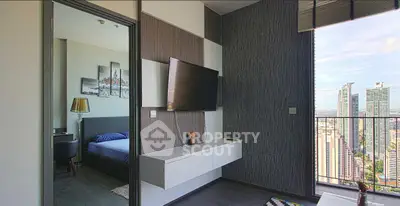 Modern apartment with sleek living room and stunning city view from balcony.