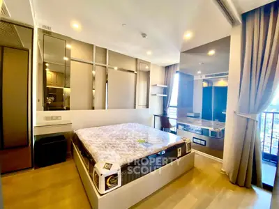 Modern bedroom with large windows and stylish decor in a luxury apartment.