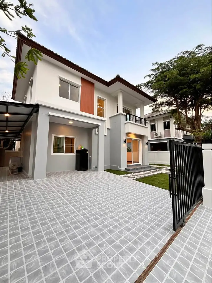 Modern two-story house with spacious driveway and lush greenery, perfect for family living.