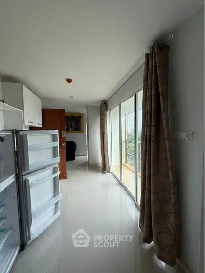 Bright kitchen with open layout and large windows in modern apartment