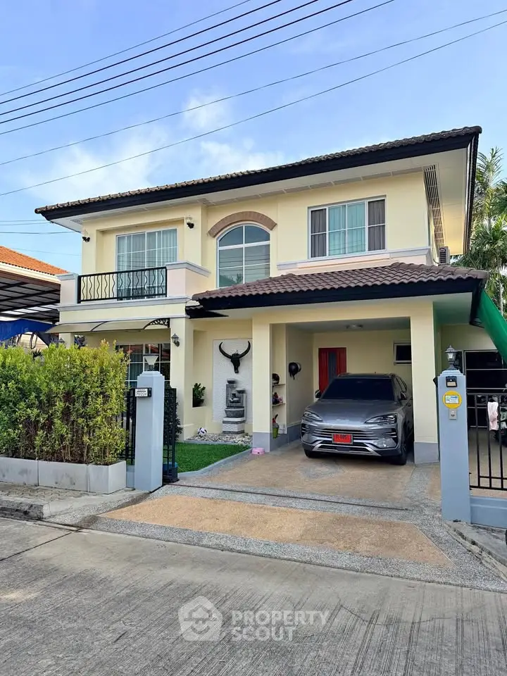 Charming two-story house with a carport and lush greenery in a serene neighborhood.