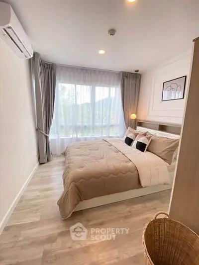 Cozy modern bedroom with large window and stylish decor