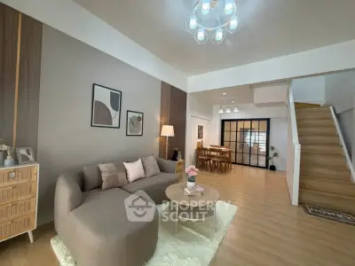 Spacious modern living room with stylish decor and cozy seating area.