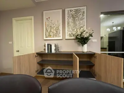 Stylish living room with elegant wooden cabinet and floral decor