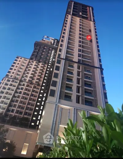 Stunning high-rise building exterior with modern architecture and lush greenery at dusk.