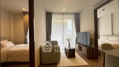 Modern apartment interior with cozy living room and two bedrooms, featuring elegant decor and natural light.