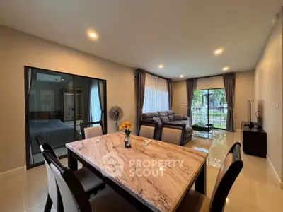 Spacious open-plan living and dining area with modern furnishings and large windows.