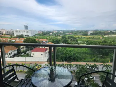 Stunning balcony view overlooking lush greenery and cityscape, perfect for relaxation and enjoyment.