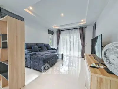 Spacious modern living room with plush sofa and large windows