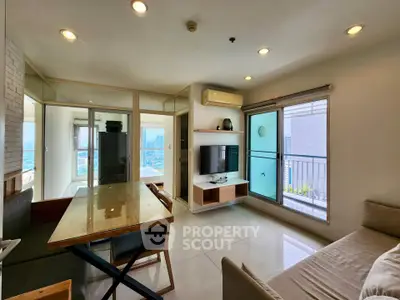Modern living room with dining area and balcony view in high-rise apartment