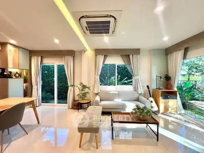 Spacious modern living room with elegant decor and garden view, perfect for relaxation and entertaining.