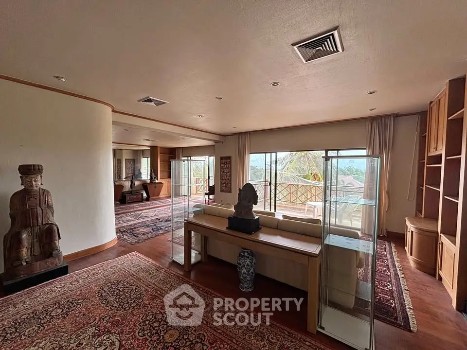 Spacious living room with elegant decor and large windows offering scenic views