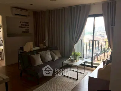 Cozy living room with modern decor and city view from balcony.