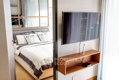 Modern bedroom with wall-mounted TV and stylish decor