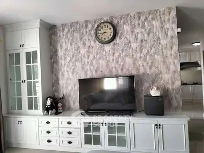 Stylish living room with elegant cabinetry and wall-mounted TV, perfect for modern living.