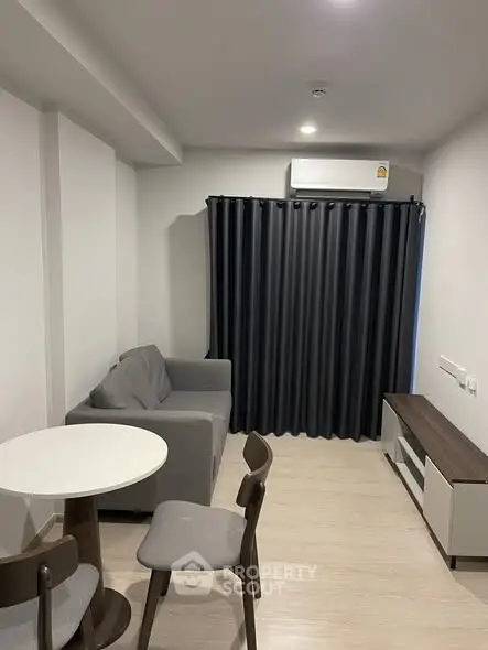 Modern living room with sleek furniture and air conditioning, perfect for cozy urban living.