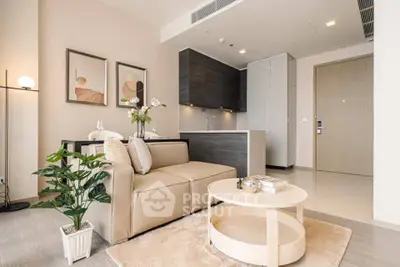 Modern living room with stylish decor and open kitchen layout in a cozy apartment.