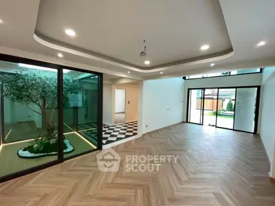 Spacious modern living room with elegant flooring and large windows for natural light.