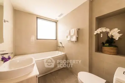 Luxurious bathroom with elegant bathtub and modern fixtures in a serene setting.
