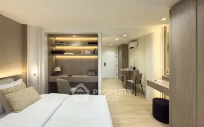 Luxurious modern bedroom with elegant decor and built-in study area, perfect for comfort and productivity.