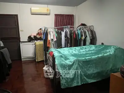 Cozy bedroom with air conditioning and ample closet space, perfect for comfortable living.
