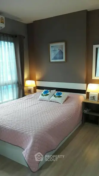 Cozy bedroom with soft lighting and modern decor, featuring a comfortable bed and stylish artwork.