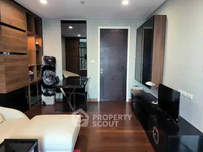 Modern living room with sleek furniture and wooden accents, featuring a cozy dining area and stylish decor.