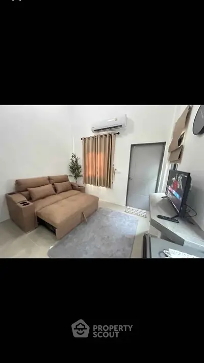 Modern living room with cozy sofa, air conditioning, and stylish decor