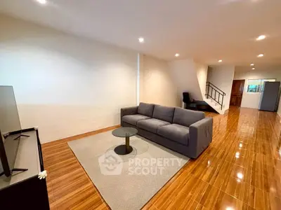 Spacious living room with modern sofa and sleek wooden flooring