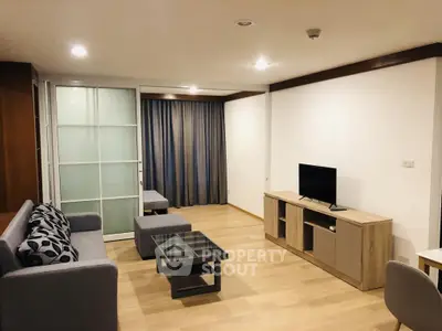 Spacious modern living room with stylish furniture and wooden flooring