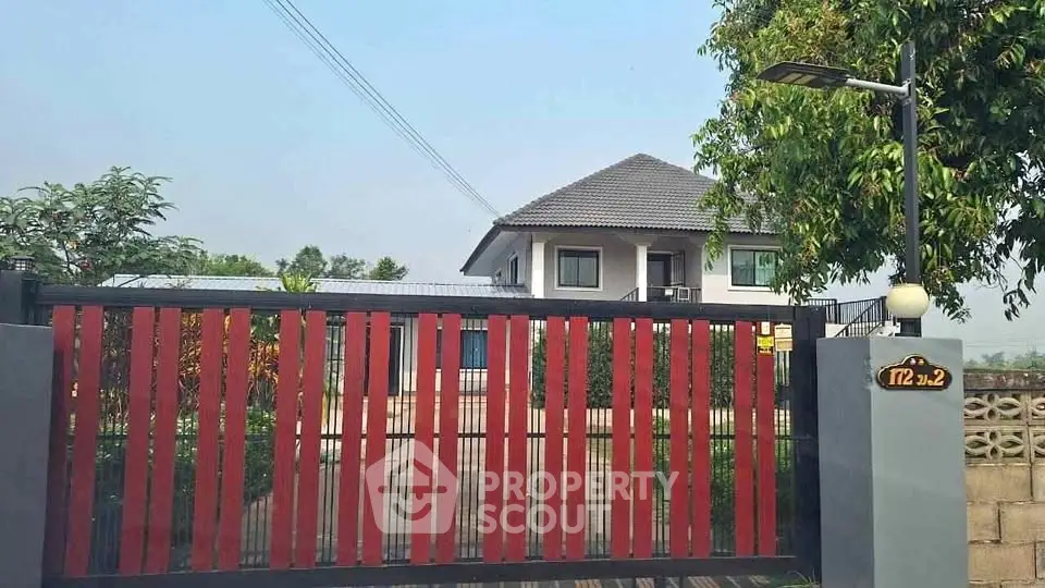 Charming suburban home with modern gate and lush greenery, perfect for family living.