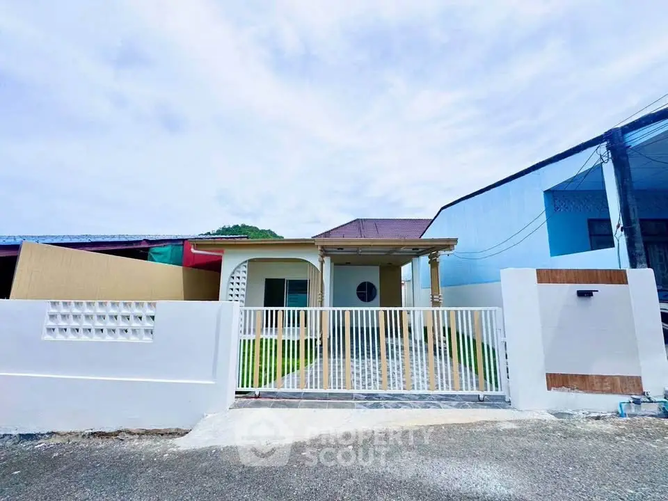 Charming single-story home with gated entrance and spacious front yard, perfect for family living.