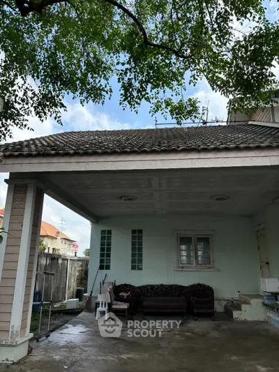 Charming suburban home with spacious covered patio and lush greenery