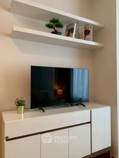 Modern living room with sleek TV stand and stylish shelving