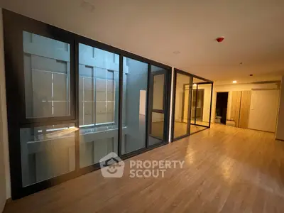 Spacious modern interior with large glass windows and wooden flooring