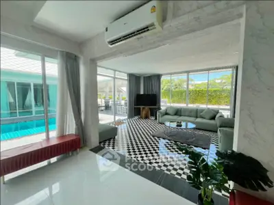 Luxurious living room with pool view and modern decor